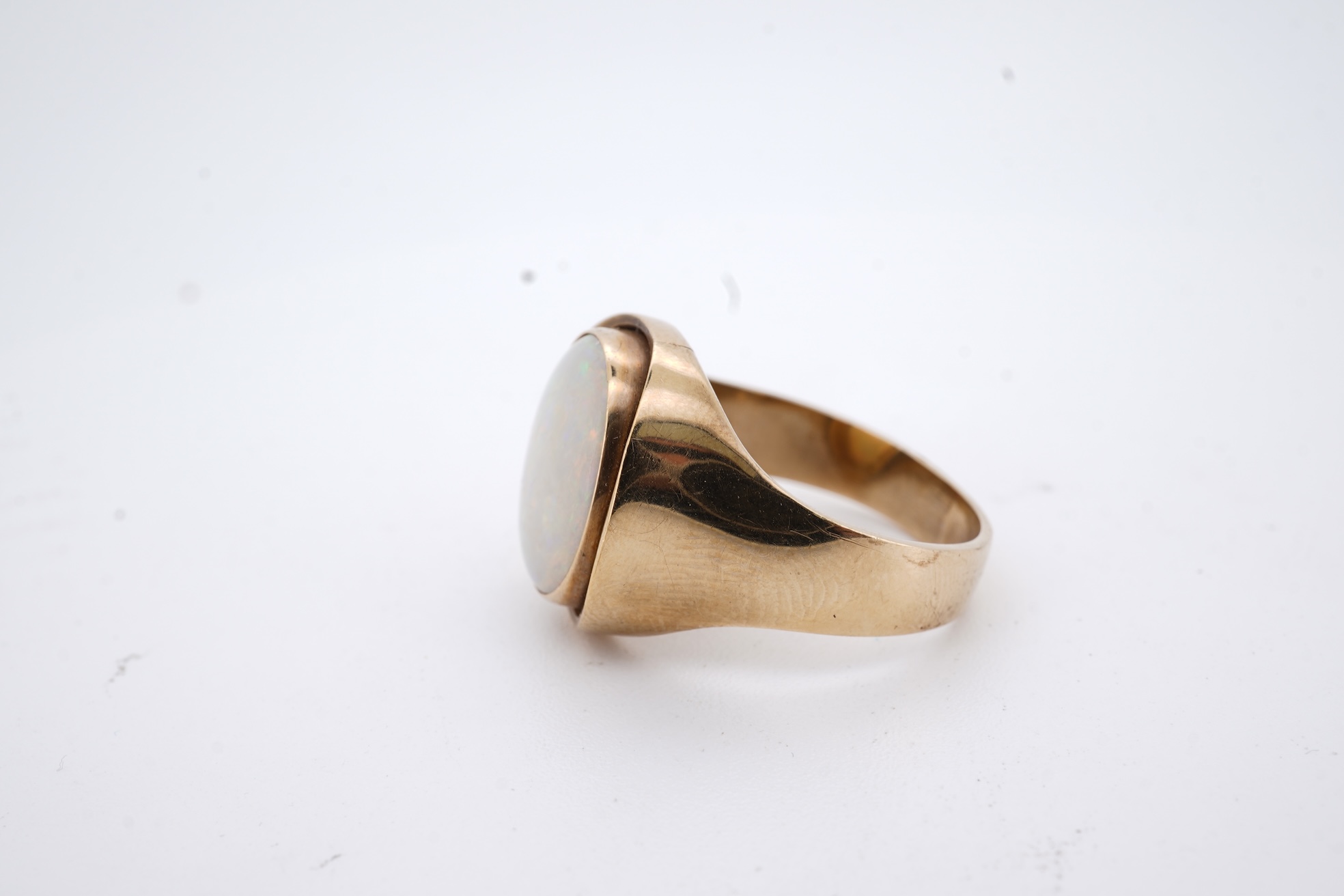 A 9ct and single stone cabochon white opal set ring, size K/L, gross weight 5 grams.